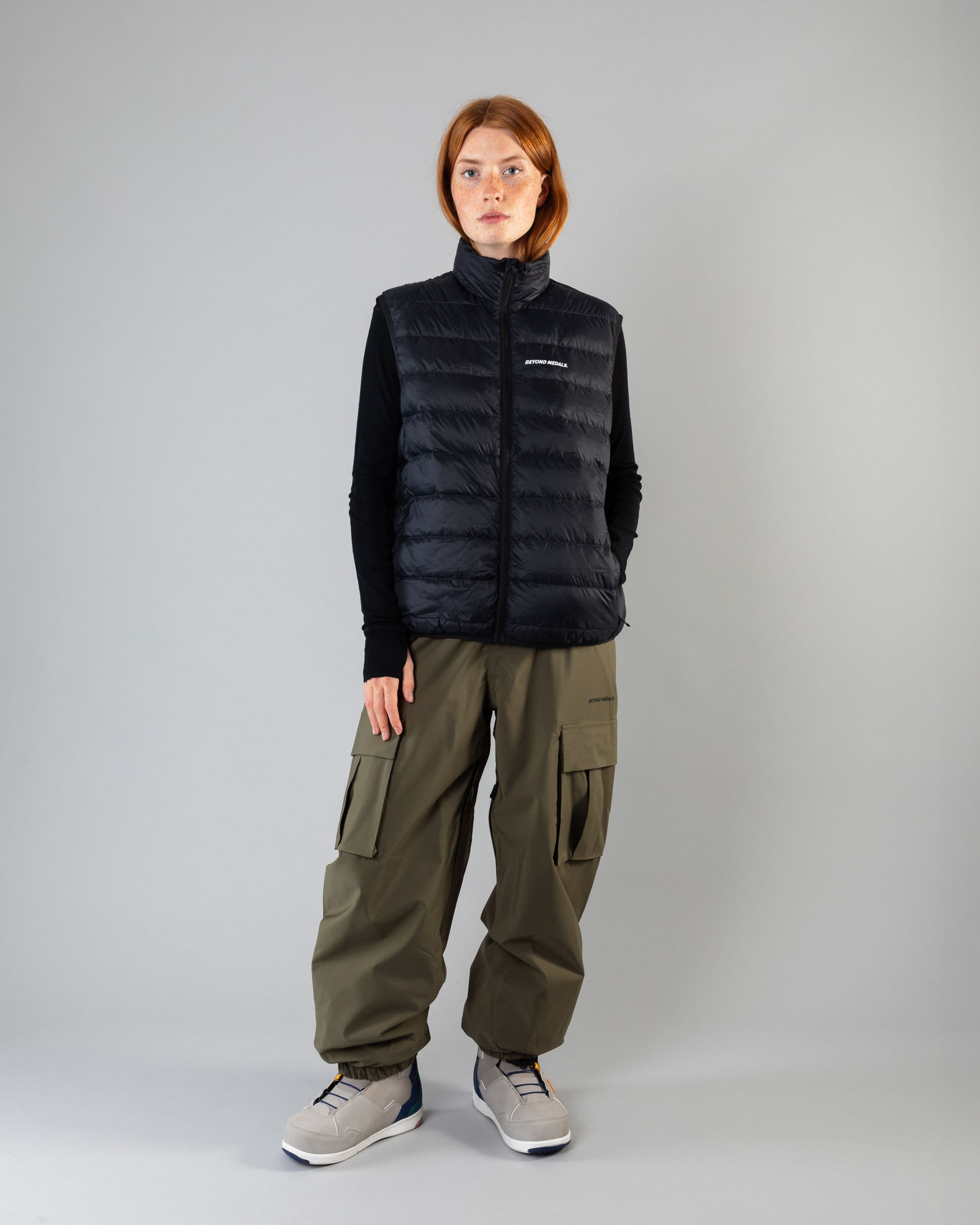 Outerwear clothing, packable down vest in black worn by model, Beyond Medals, 2024, full front